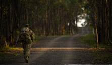 Soldier walking along a dirt road