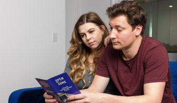A woman and man read a brochure
