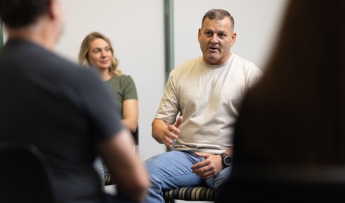 A man speaks to a group of people