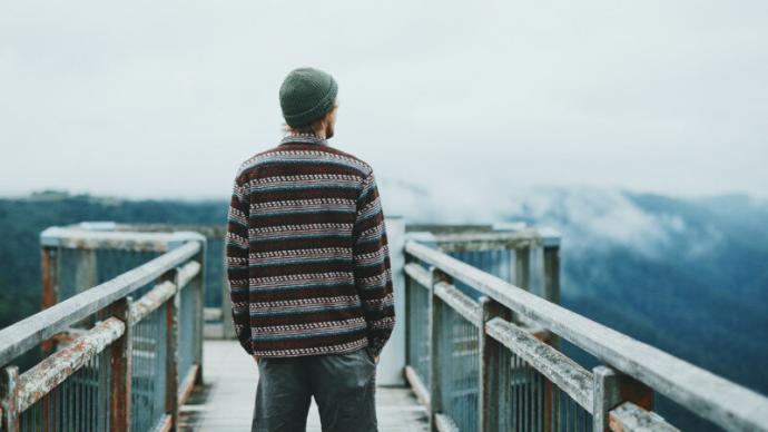 man looking out into wilderness