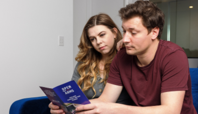 A woman and man read a brochure