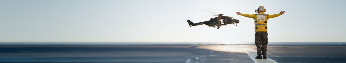 Person with open arms guiding helicopter